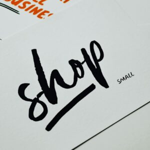 A close-up of a card with 'shop small' message promoting local small businesses.